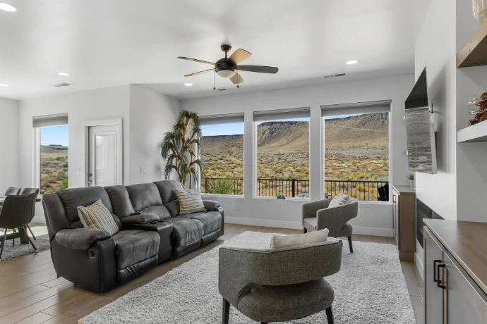 Great room with three large picture windows facing a red rock mesa, Washington, Utah